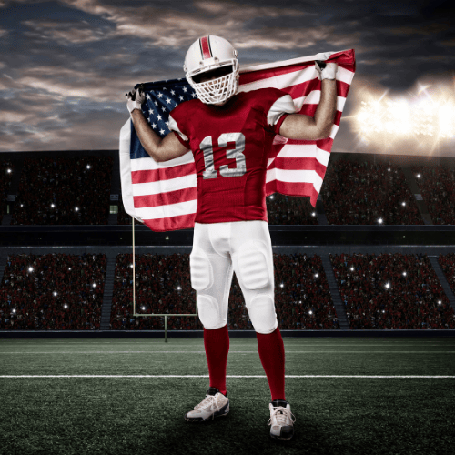 Football player in red jersey holding American flag, representing American-made quality and patriotic values